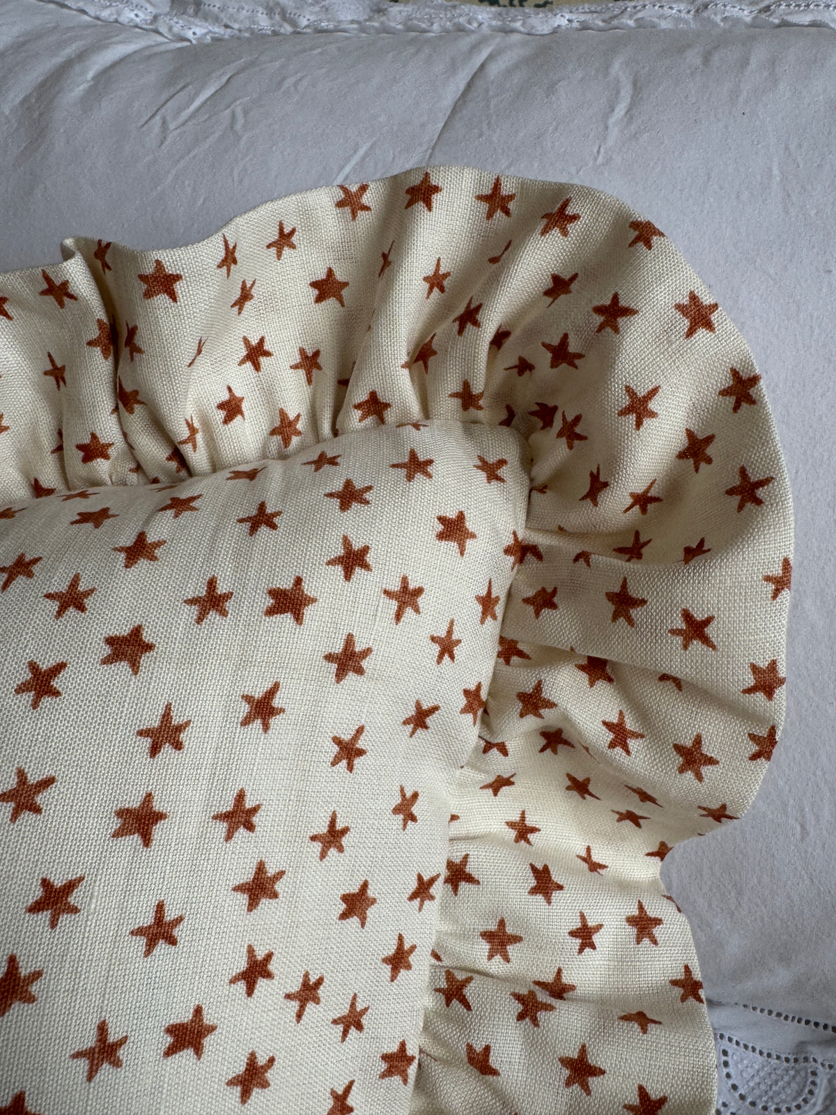 ‘Bigger Than the Baby’ Chelsea Textiles Stars Rust Cushion